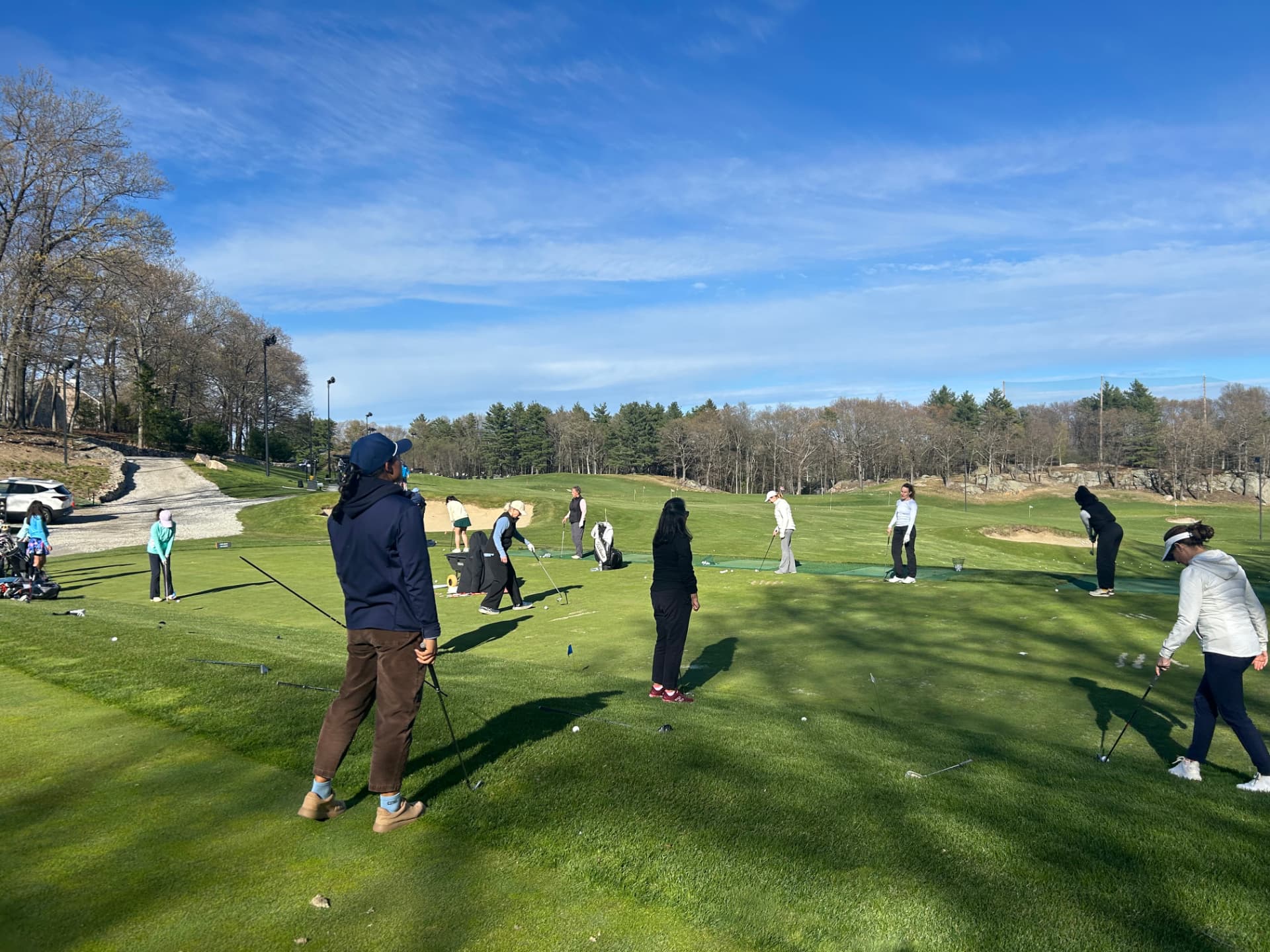 Group of adult golfers practicing on the KOHR short game area