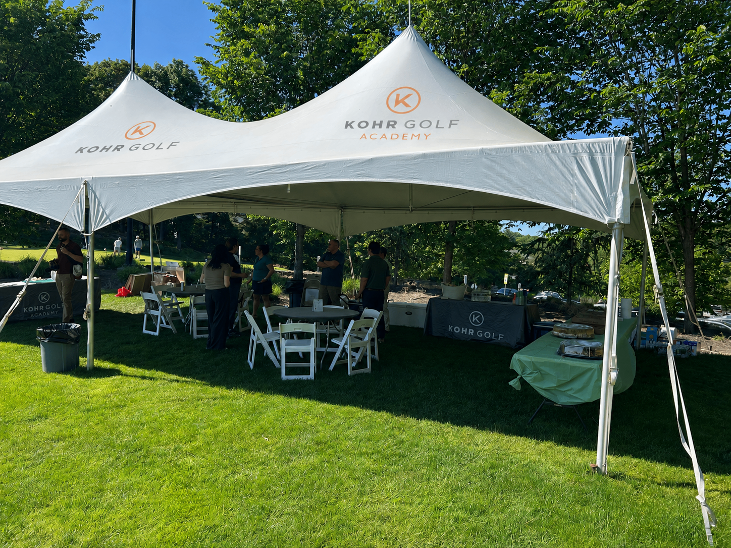 KOHR Golf branded event tent on the lawn