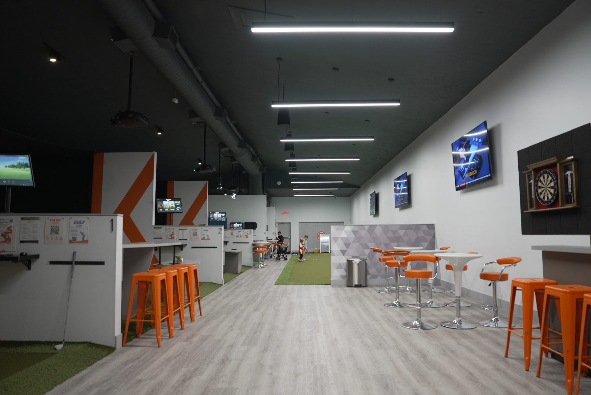 Golfer hitting into a TrackMan simulator inside a KOHR indoor bay